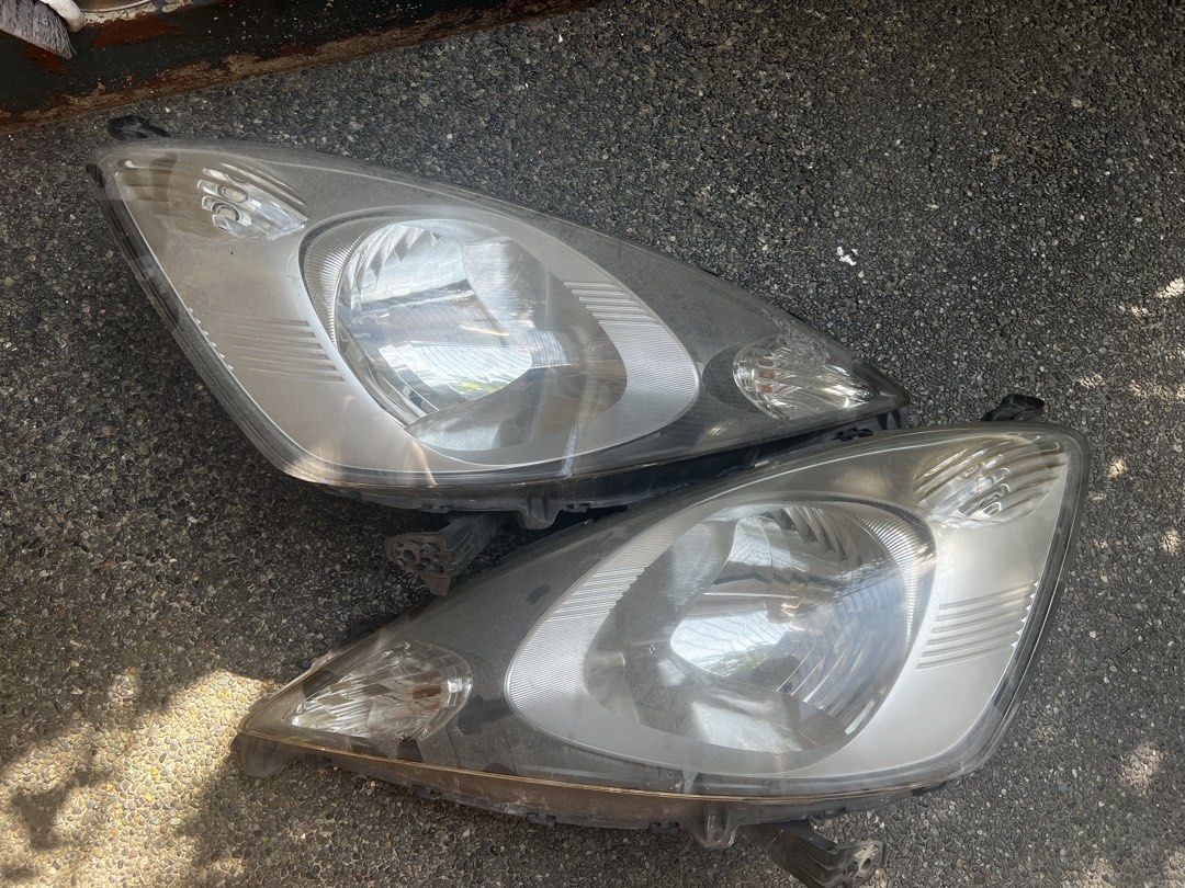 Honda Jazz GE Pre - MMC Headlight Assembly (Category: Lightings, Horns, and other Electrical Parts and Accessories) located in Quezon City. Submitted by digital_ryan (Listing ID 1469283738, Image 2). Description: For Sale: Used Honda Jazz GE Pre- MMC Headlight Assembly With FREE Novsight LED Bulb Complete Brackets issue: Sun Peeling but does not affect light .