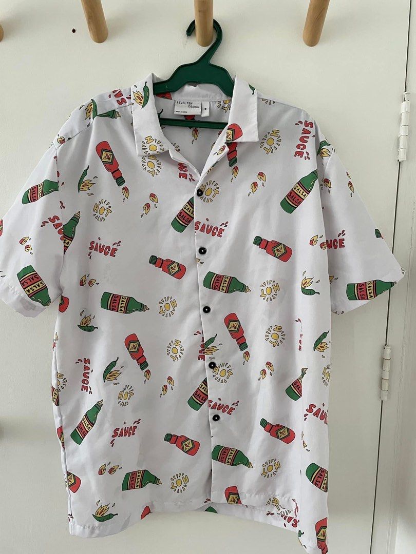 Hot Sauce Print Polo - M (Category: Tshirts & Polo Shirts ) located in Cainta. Submitted by pnedp2022 (Listing ID 1469211275, Image 1). Description: - Brand: Level Ten Design (from BKK) - Size: Medium - Condition 10/10 used once - Loc: Greenwoods Pasig/Cainta.