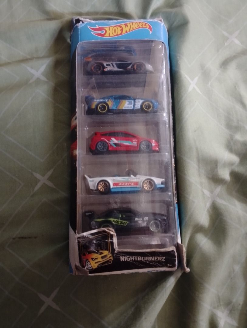 Hot Wheels Nightburnerz 5-Car Pack (Category: Vehicle & Diecast Models) located in Manila. Submitted by marthasiah09 (Listing ID 1469243577, Image 1). Description: - Item: Hot Wheels Nightburnerz 5-Car Pack - Condition: Brand new, unopened packaging (Note: Box has minor shelf wear and corner damage) - Vehicles Included: 5 die-cast sports cars and sedans - Colors & Graphics: Multi-color (blue, red, white, black) with custom graphics - Perfect for 