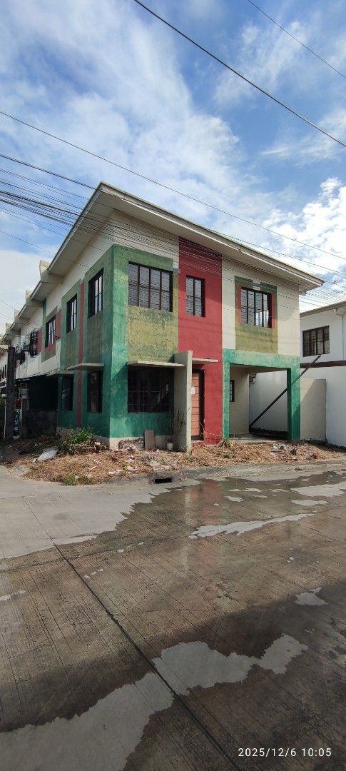 House and lot for assume (Category: House & Lot) located in Dasmarinas. Submitted by jdelacruz0728 (Listing ID 1469228019, Image 1). Description: House and lot for assume Golden Horizon Trece Martires Cavite - Multi-storey townhouse with modern red, green, and cream exterior - Ready for occupancy with clean, well-maintained lines - Ground floor includes a designated car garage space - Convenient concrete driveway alongside the structure - Bright 