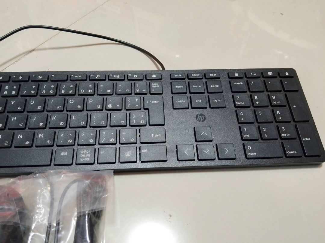 HP keyboard and Mouse (Tested smooth) (Category: Computer Parts) located in San Leonardo. Submitted by burgossanleonardo.12345 (Listing ID 1469265593, Image 3). Description: • Keyboard Type: Compact/mini wired USB keyboard with Japanese character sub-legends (Kana/Kanji) on the keycaps. • Accessories Included: A wired USB optical mouse in packaging. • Layout: 78-key.