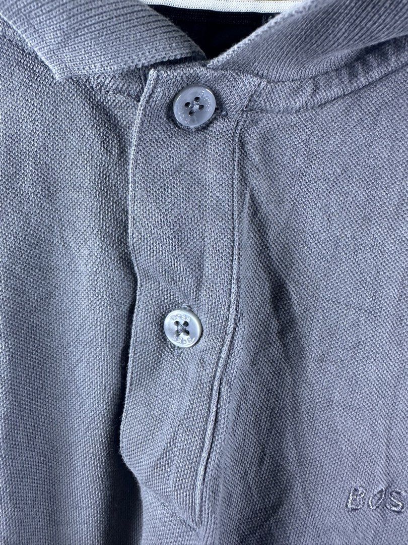 Hugo Boss Grey Polo Shirt (Category: Tshirts & Polo Shirts ) located in Manila. Submitted by declutterpromax (Listing ID 1469214620, Image 3). Description: - Brand: Boss - Color: Grey - Material: Clean cotton knit fabric - Design: Two-button placket, embroidered logo on the chest, and side slits with a small black brand tag - Measurements: 19 inches across the chest by 25 inches in length - Condition/Style: Great staple piece for casual wear.