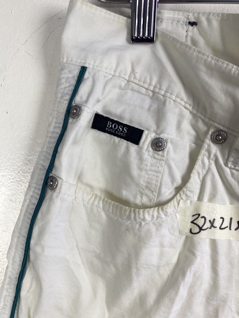 Hugo Boss White Casual Shorts (Category: Shorts) located in Manila. Submitted by declutterpromax (Listing ID 1469201981, Image 3). Description: - Brand: Hugo Boss - Color: White with green piping accents - Size: 32x21 - Details: Branded metal buttons, logo patch on back waistband, and multiple functional pockets - Condition: Clean construction, great for the summer wardrobe.