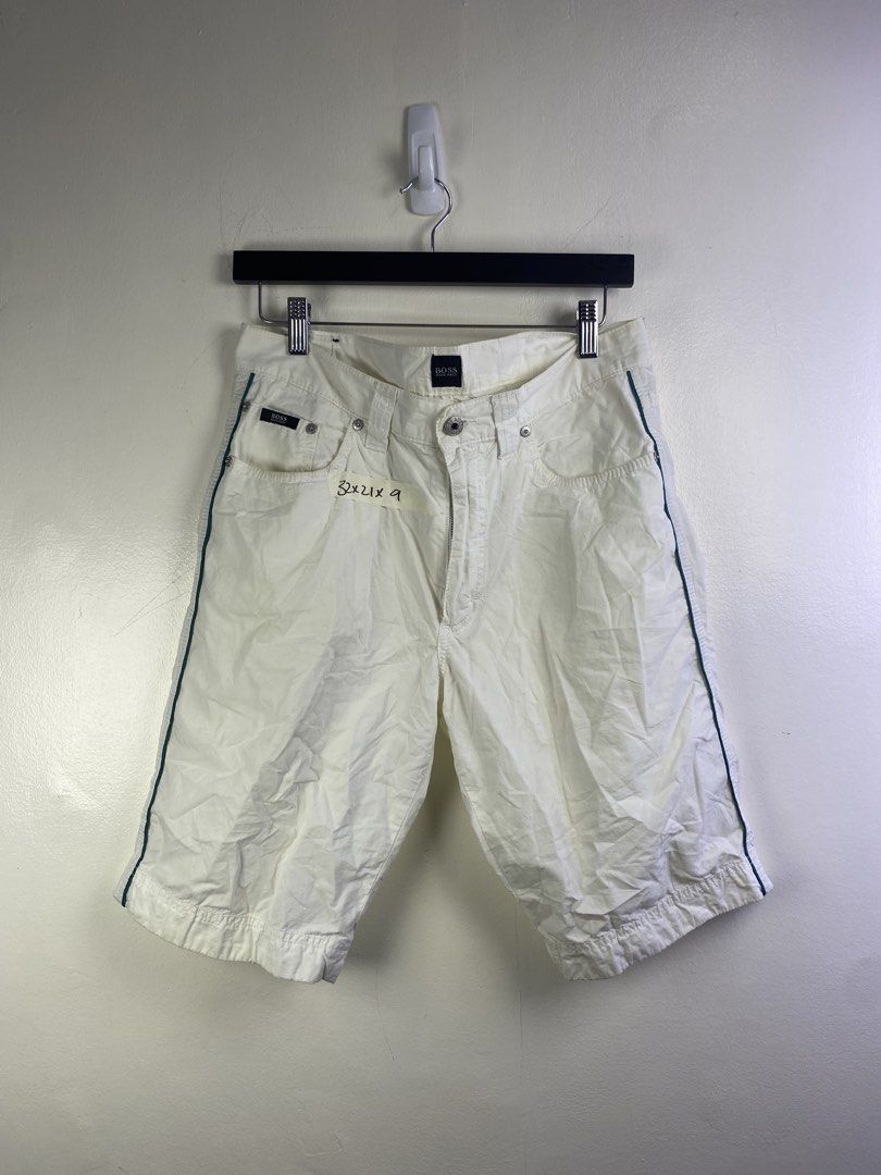 Hugo Boss White Casual Shorts (Category: Shorts) located in Manila. Submitted by declutterpromax (Listing ID 1469201981, Image 1). Description: - Brand: Hugo Boss - Color: White with green piping accents - Size: 32x21 - Details: Branded metal buttons, logo patch on back waistband, and multiple functional pockets - Condition: Clean construction, great for the summer wardrobe.