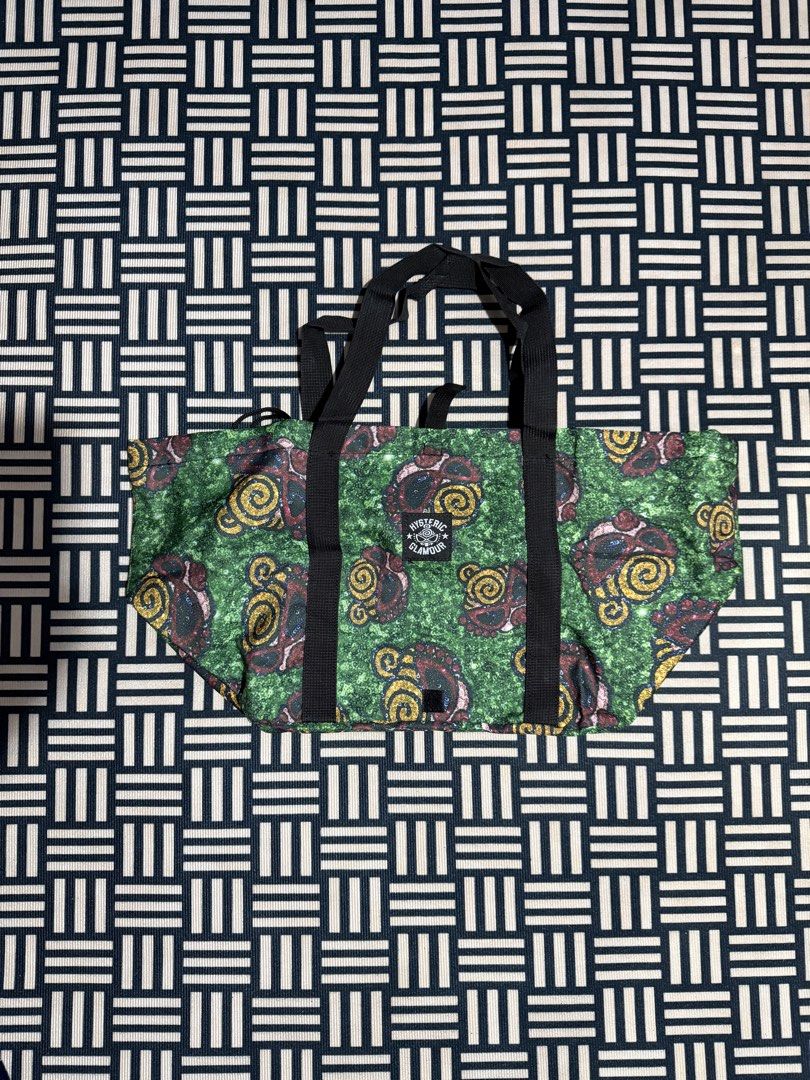 Hysteric Glamour Green Pattern Tote Bag (Category: Tote Bags) located in Manila. Submitted by garcianath68674 (Listing ID 1469285165, Image 1). Description: - Brand: Hysteric Glamour - Color: Green with all-over graphic pattern - Straps: Black double shoulder straps - Features: Front woven brand patch, spacious interior, branded inner lining, and secure drawstring closure - Condition: Excellent everyday bag, perfect for carrying daily essentials 