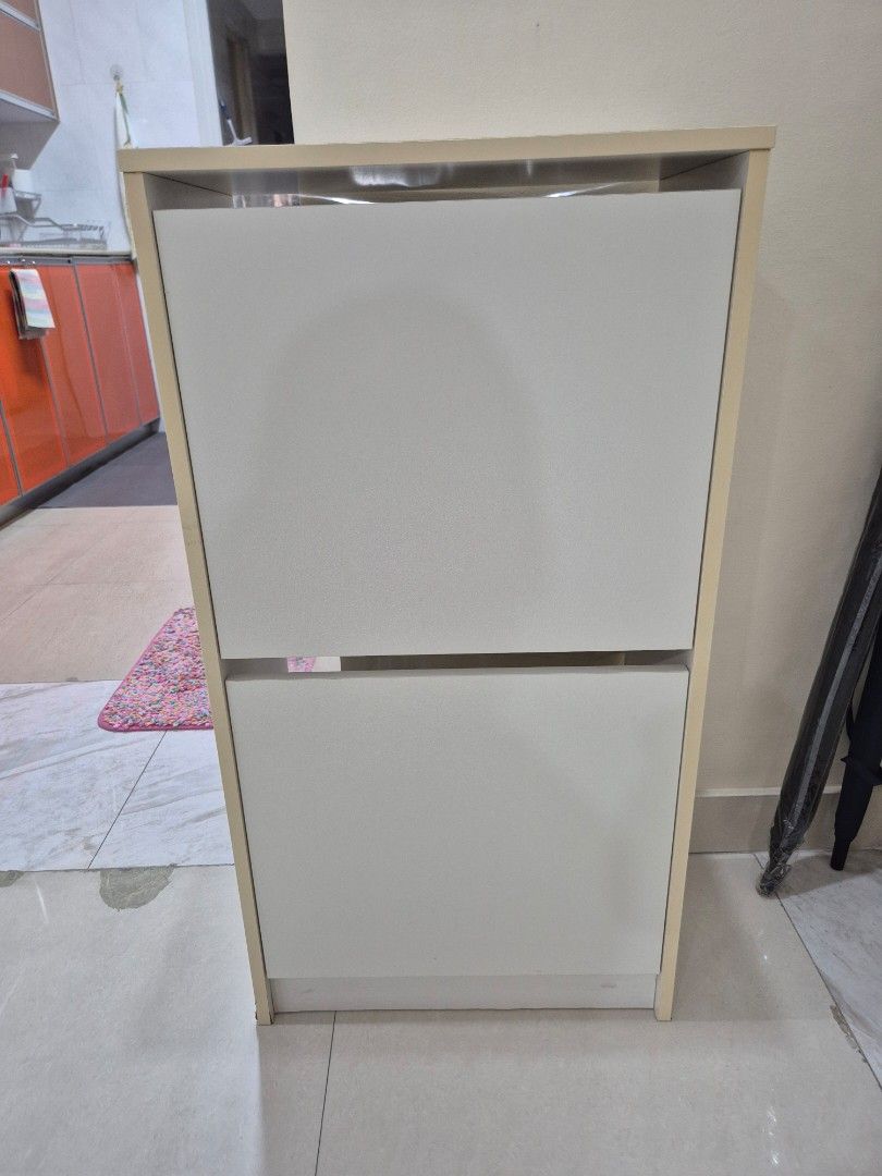 Ikea "Bissa" Shoe Cabinet with 2 Compartments White (Category: Shelves, Cabinets & Racks) located in Manila. Submitted by Jenshoppe (Listing ID 1469251057, Image 1). Description: Ikea "Bissa" Shoe Cabinet 2 Layer White Size: 19 1/4" x 11" x 36" height ● 2nd hand, no issues, taken care well ● help you organize your shoes and saves floor space at the same time ● 2 layer can put 8 adult shoes ● In the shoe cabinet your shoes get the ventilation and 