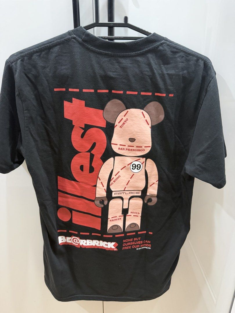 Illest x Bearbrick Black T-Shirt Medium (Category: Tshirts & Polo Shirts ) located in San Pedro. Submitted by tineodulio (Listing ID 1469265368, Image 2). Description: - Brand/Collaboration: Illest x Bearbrick - Color: Black - Size: Medium (Designed in USA) - Design: Small chest graphic print and large back graphic print - Fit/Style: Crew neck, short sleeves - Material: Clean cotton fabric - Condition: Minor everyday wear around the collar ribbin