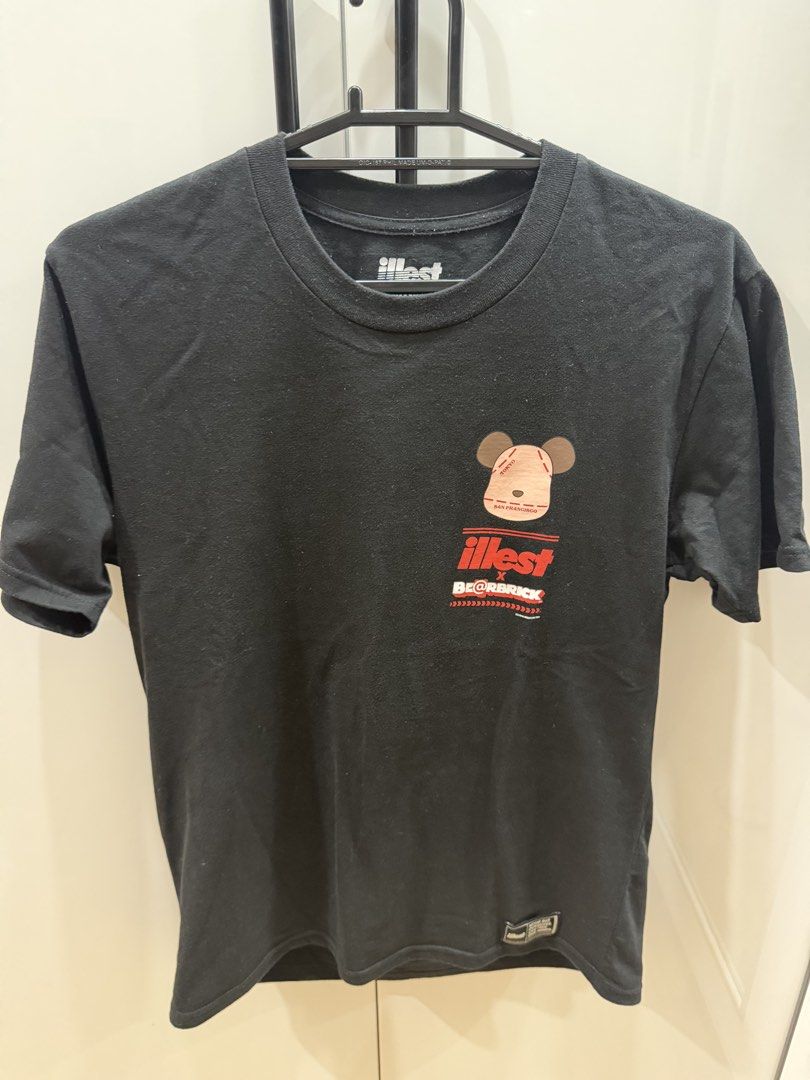 Illest x Bearbrick Black T-Shirt Medium (Category: Tshirts & Polo Shirts ) located in San Pedro. Submitted by tineodulio (Listing ID 1469265368, Image 1). Description: - Brand/Collaboration: Illest x Bearbrick - Color: Black - Size: Medium (Designed in USA) - Design: Small chest graphic print and large back graphic print - Fit/Style: Crew neck, short sleeves - Material: Clean cotton fabric - Condition: Minor everyday wear around the collar ribbin