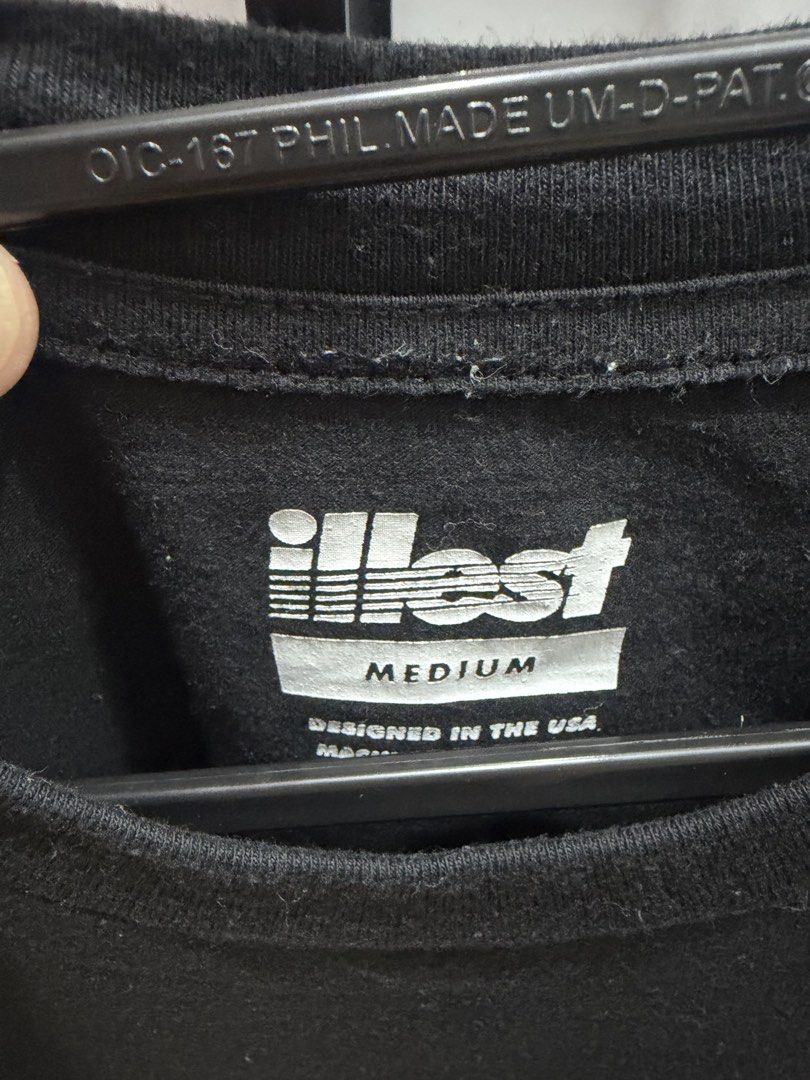 Illest x Bearbrick Black T-Shirt Medium (Category: Tshirts & Polo Shirts ) located in San Pedro. Submitted by tineodulio (Listing ID 1469265368, Image 3). Description: - Brand/Collaboration: Illest x Bearbrick - Color: Black - Size: Medium (Designed in USA) - Design: Small chest graphic print and large back graphic print - Fit/Style: Crew neck, short sleeves - Material: Clean cotton fabric - Condition: Minor everyday wear around the collar ribbin