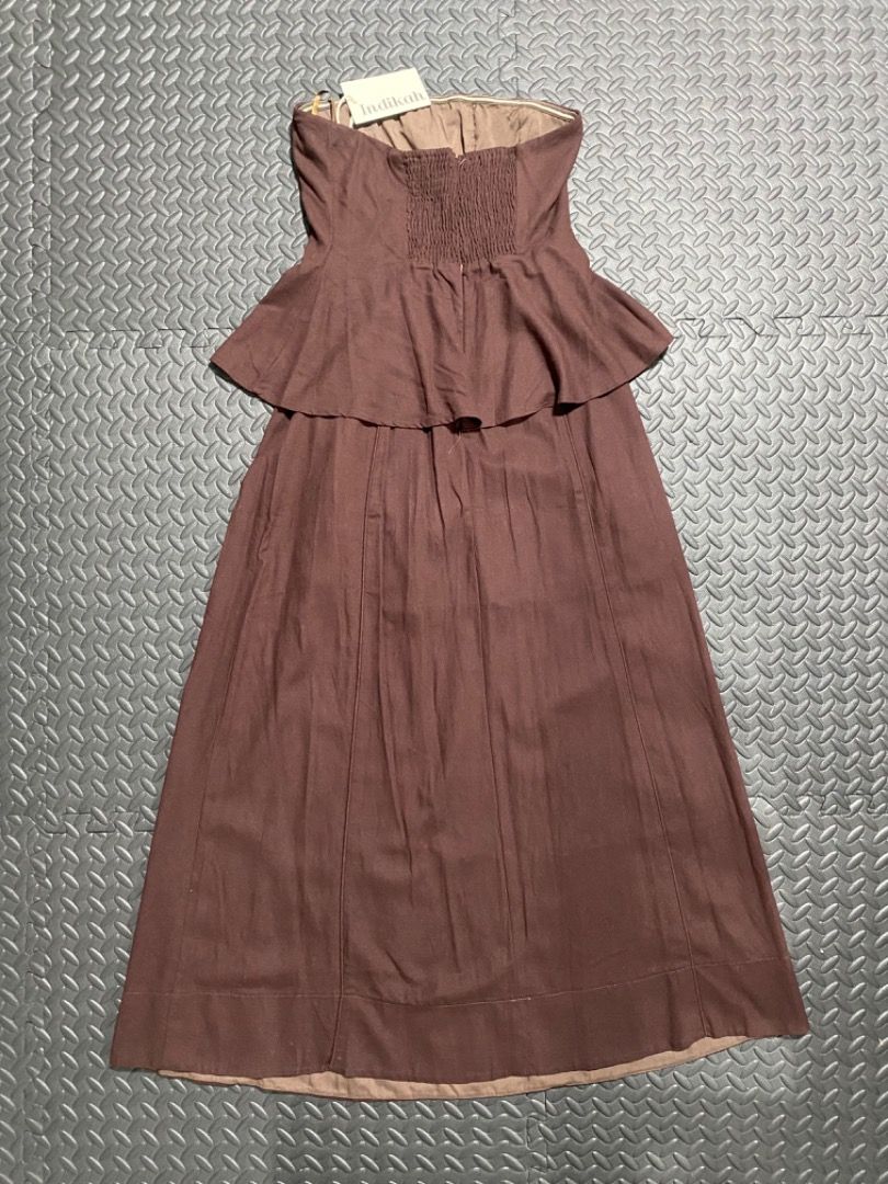 Indikah Brown Strapless Peplum Maxi Dress (Category: Dresses) located in Manila. Submitted by everydrei (Listing ID 1469203621, Image 2). Description: - Brand: Indikah (Tag still attached at neckline) - Style: Brown strapless maxi dress - Fit: Fitted bodice with a stretchy smocked back panel - Details: Layered peplum detail at the waistline and a long flowing skirt with panel stitching - Condition: Brand new with tag -RFS: Wrong size.