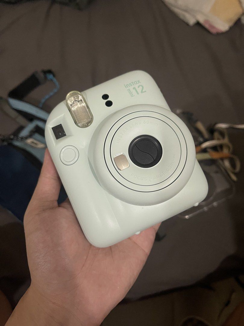 Instax Mini 12 (Category: Cameras) located in Cainta. Submitted by vanseal (Listing ID 1469228814, Image 2). Description: Instax mini 12 mint green - with original sling bag from club kit - with hand strap - with case - only used once - NO ISSUES - price negotiable for sure buyer .