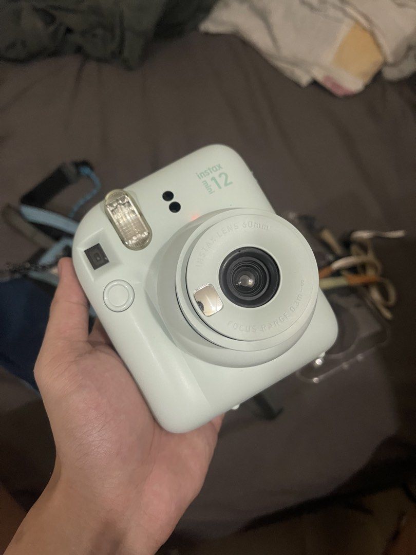 Instax Mini 12 (Category: Cameras) located in Cainta. Submitted by vanseal (Listing ID 1469228814, Image 3). Description: Instax mini 12 mint green - with original sling bag from club kit - with hand strap - with case - only used once - NO ISSUES - price negotiable for sure buyer .