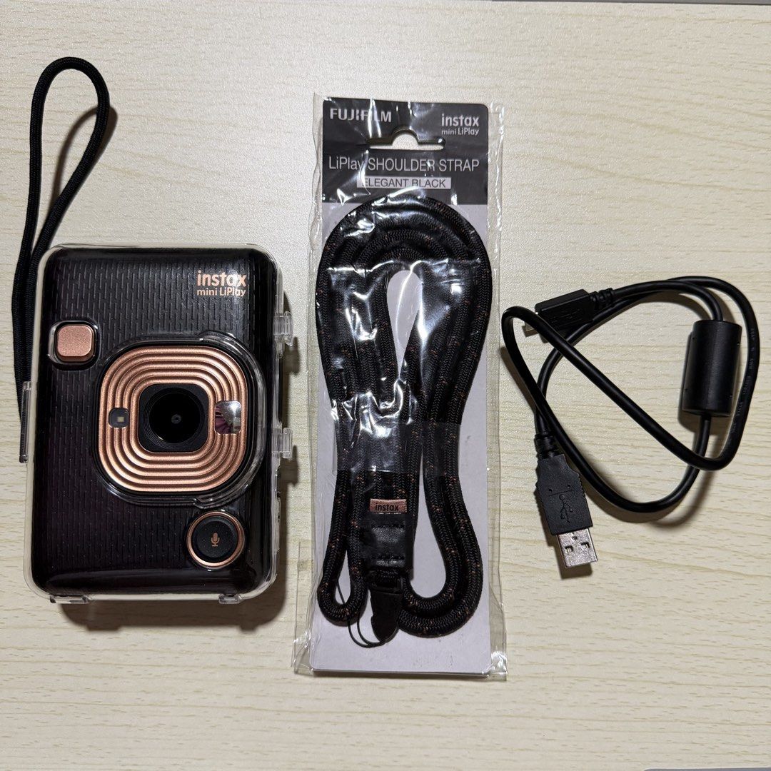 Instax Mini LiPlay (Category: Cameras) located in Las Pinas. Submitted by camchii (Listing ID 1469318903, Image 1). Description: ✨ Condition: Fully functional, well-maintained, and in great condition. •No scratches •Minor cosmetic wear: The silicone cover for the SD card slot is torn but still covers the port. Inclusions: •Original Charger •Clear Acrylic Case •Hand Strap •Shoulder Strap (Unused) •SanDisk Ultra Micro SD 16gb Reason for Selling: Ba