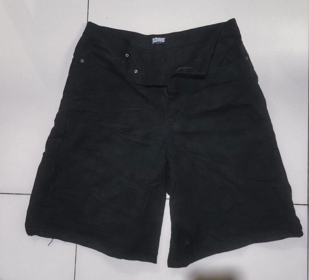 Ione Denim Shorts Black (Category: Shorts) located in San Carlos City. Submitted by dhong_abay_thrift (Listing ID 1469201130, Image 2). Description: - Brand: Ione - Color/Wash: Black denim, dark wash - Closure: Standard button fly - Fit: Straight cut - Details: Back patch pockets with branded logo patch and waistband label - Style: Versatile everyday streetwear essential - Condition: Excellent / Ready to ship 30-32 waist x 23L x 13.5 hem.