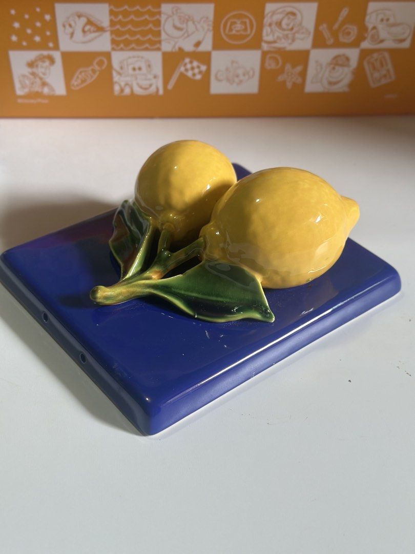Italian ceramic wall tile featuring two yellow lemons (Category: Other Home Decor) located in Davao. Submitted by favoritepreloved (Listing ID 1469205240, Image 3). Description: 💜 with green leaves in relief set against a deep blue background 💜 16cm x 16cm 💜 Made in Italy 💜 Flaws: meron small chip sa back part pero di kita sa harap.