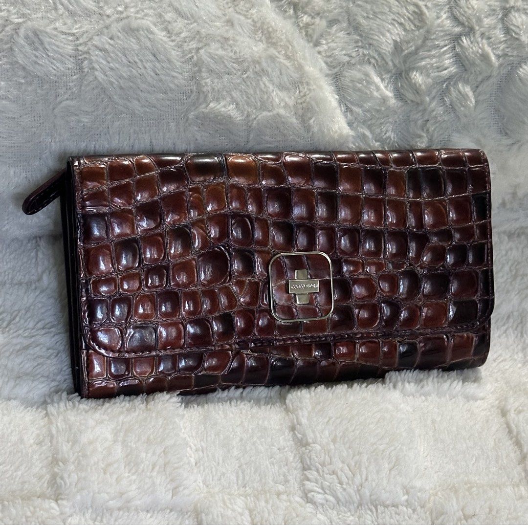 Italy Croc Embossed Long Wallet! (Category: Wallets & Card holders) located in Santa Rosa. Submitted by esplanamur03635 (Listing ID 1469230611, Image 2). Description: Authentic Italy Cocco Fiore bifold long wallet in saffiano leather glossy brown croc-embossed leather, silver hardware soft leather clean pink logo-print interior multiple card slots, slip pockets, and a middle zip coin pocket YKK zipper No flaws very excellent condition Good as new