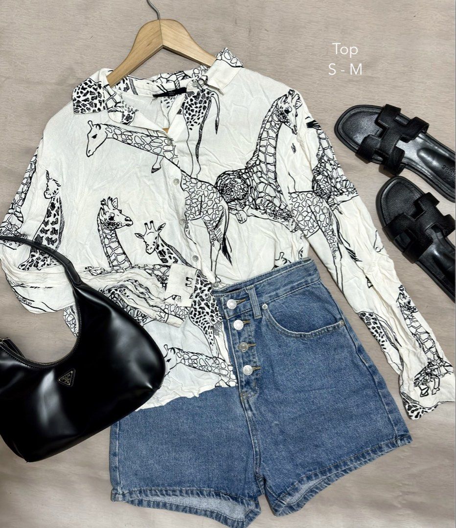 Jane + Delancey Giraffe Print Button-Down Top S-M (Category: Blouses) located in Caloocan City. Submitted by nnnprelovedclothes (Listing ID 1469383051, Image 1). Description: - Design: Chic black giraffe print on white fabric - Details: Collared neckline, long sleeves, front button closure .