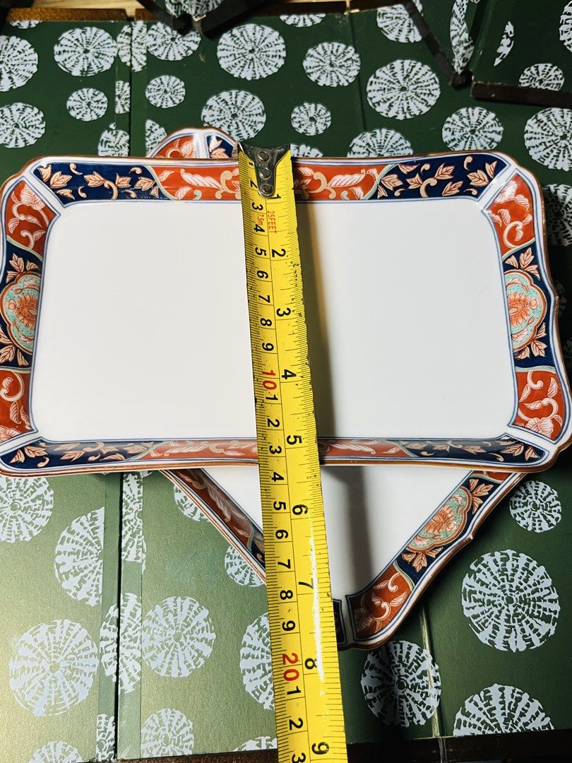 Japanese Ceramic Rectangular Serving Plates Set of 2 (Category: Dinnerware & Cutlery) located in Malabon City. Submitted by mgsurplus (Listing ID 1469192995, Image 3). Description: - Set of 2 rectangular ceramic trays with a traditional Japanese aesthetic - Features vibrant blue and orange floral borders and delicate side branch paintings - Dimensions: Roughly 8.5 inches by 5.5 inches each - Space-saving stackable design for easy cupboard storage