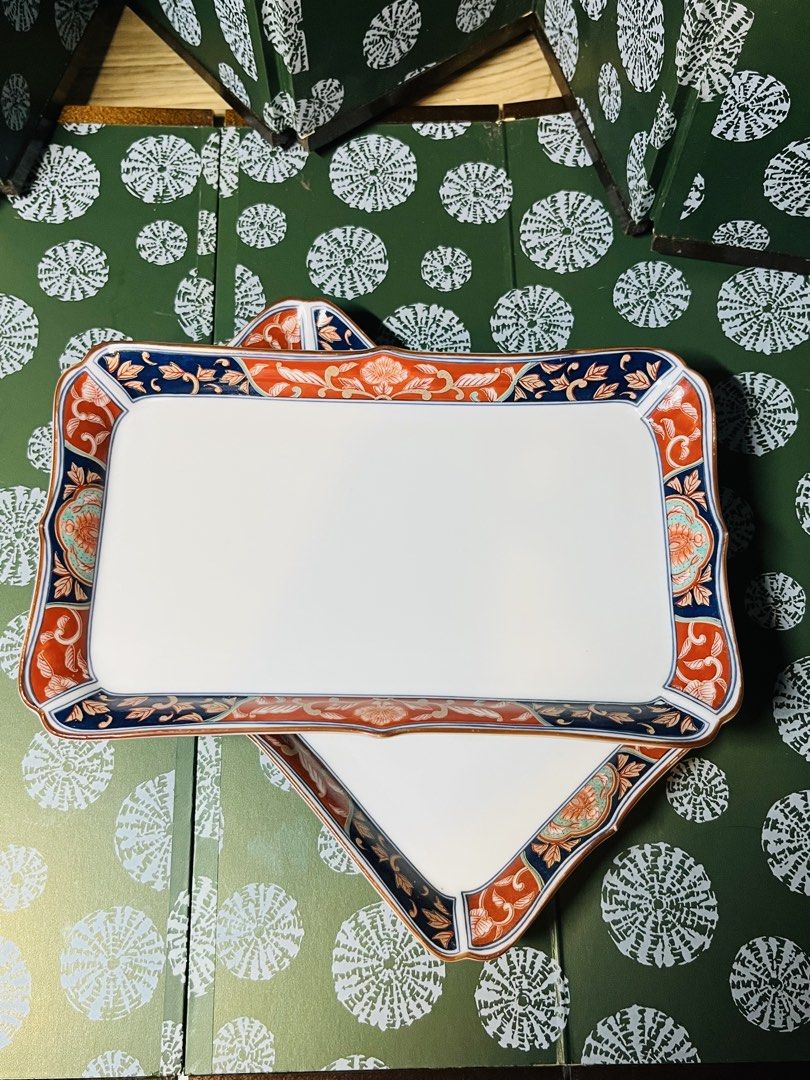 Japanese Ceramic Rectangular Serving Plates Set of 2 (Category: Dinnerware & Cutlery) located in Malabon City. Submitted by mgsurplus (Listing ID 1469192995, Image 1). Description: - Set of 2 rectangular ceramic trays with a traditional Japanese aesthetic - Features vibrant blue and orange floral borders and delicate side branch paintings - Dimensions: Roughly 8.5 inches by 5.5 inches each - Space-saving stackable design for easy cupboard storage