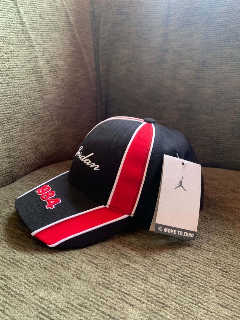 Jordan 1984 Snapback Cap Black Red (Category: Caps & Hats) located in San Juan City. Submitted by findmorelux (Listing ID 1469226015, Image 1). Description: - Authentic Jordan 1984 snapback cap - Colorway: Black with striking red panels and white piping - Embroidery: Script Jordan on front panel and 1984 numbering on the brim - Branding: Jumpman logo on the rear strap and interior taping - Fit: Adjustable black snap closure - Condition: Brand new