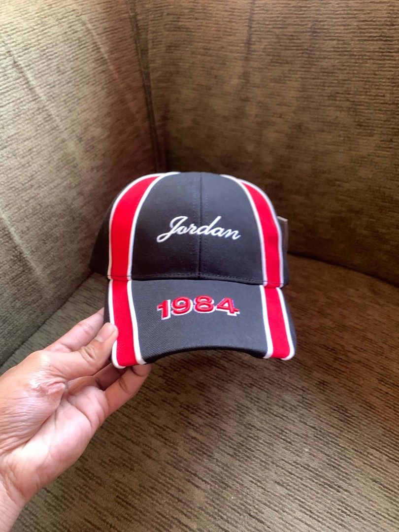 Jordan 1984 Snapback Cap Black Red (Category: Caps & Hats) located in San Juan City. Submitted by findmorelux (Listing ID 1469226015, Image 3). Description: - Authentic Jordan 1984 snapback cap - Colorway: Black with striking red panels and white piping - Embroidery: Script Jordan on front panel and 1984 numbering on the brim - Branding: Jumpman logo on the rear strap and interior taping - Fit: Adjustable black snap closure - Condition: Brand new
