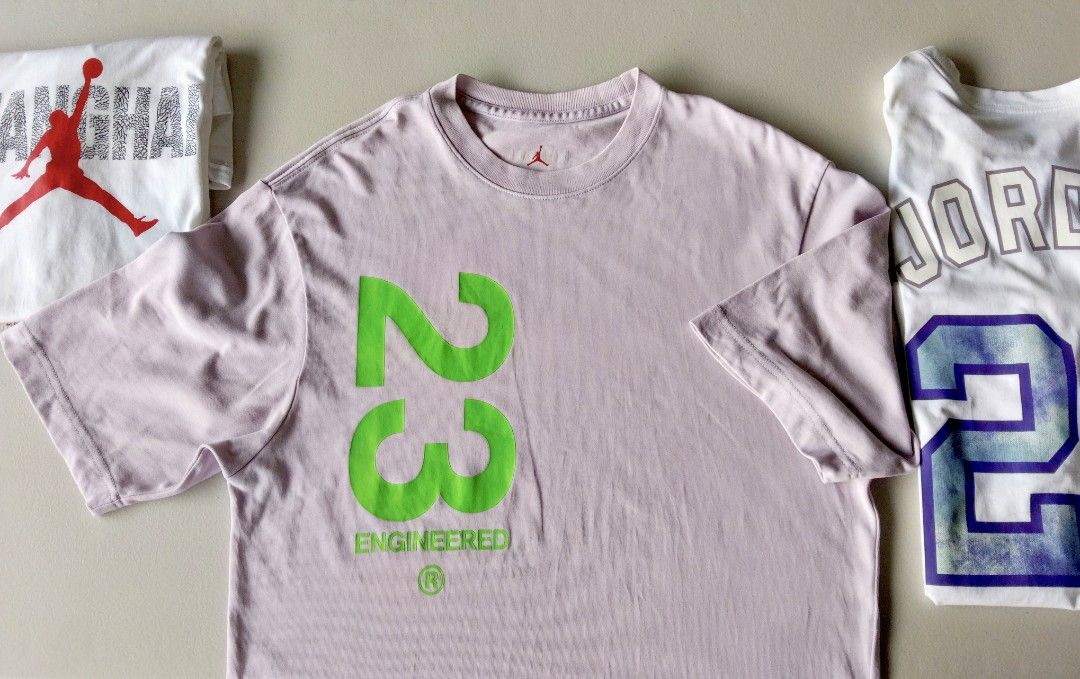 Jordan Engineered 23 Purple T-Shirt (Category: Tshirts & Polo Shirts ) located in Iloilo. Submitted by rapha.houseofactivewear.23 (Listing ID 1469208209, Image 1). Description: - Color: Light purple - Design: Large neon green '23' and Engineered branding on front, small back collar graphic - Fit: Casual short-sleeve - Condition: Excellent, clean with no stains or rips - Style: Great streetwear piece for daily wear.