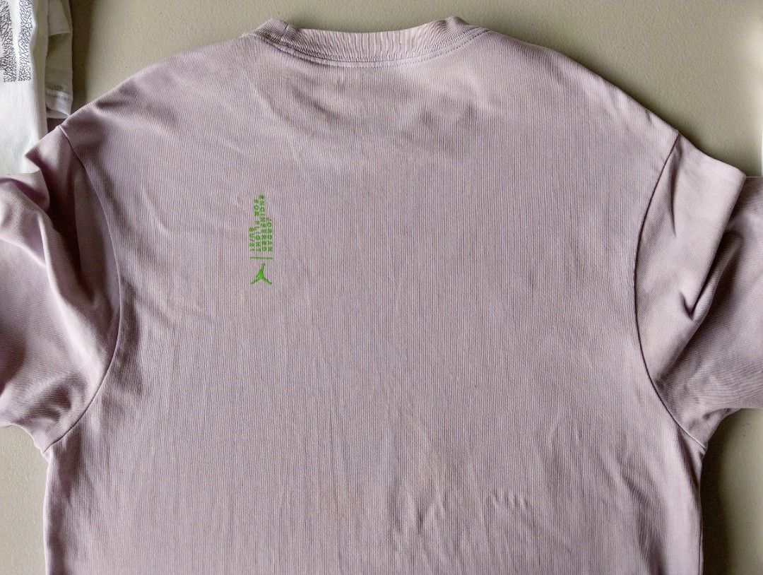 Jordan Engineered 23 Purple T-Shirt (Category: Tshirts & Polo Shirts ) located in Iloilo. Submitted by rapha.houseofactivewear.23 (Listing ID 1469208209, Image 3). Description: - Color: Light purple - Design: Large neon green '23' and Engineered branding on front, small back collar graphic - Fit: Casual short-sleeve - Condition: Excellent, clean with no stains or rips - Style: Great streetwear piece for daily wear.