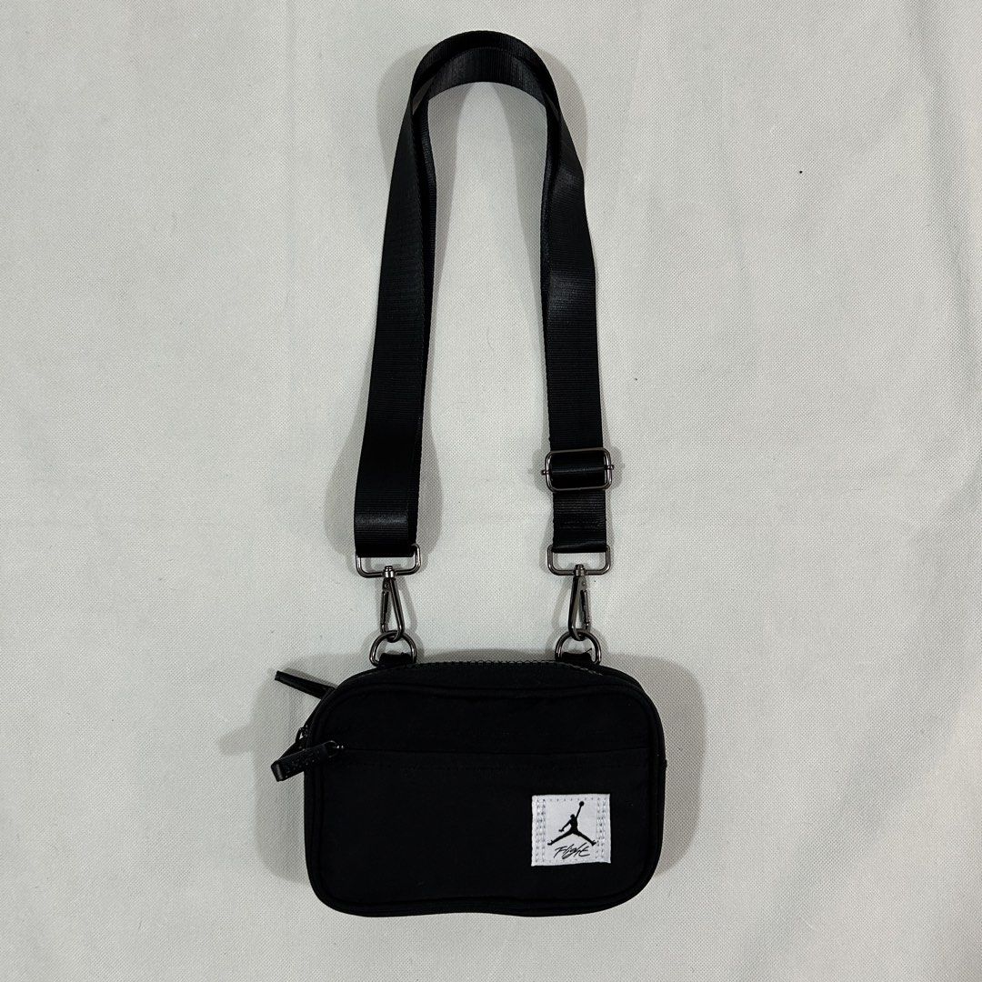 Jordan Flight Black Crossbody Bag (Category: Sling Bags) located in Cavite. Submitted by moo2k (Listing ID 1469204067, Image 1). Description: - Brand: Jordan Flight - Color: Classic black with white Flight patch - Material: Durable fabric construction - Compartments: Main zip compartment, smaller front pocket, and interior zippered pocket - Details: Woven Jordan logo patch inside - Strap: Adjustable shoulder strap with sturdy metal clips - Condit