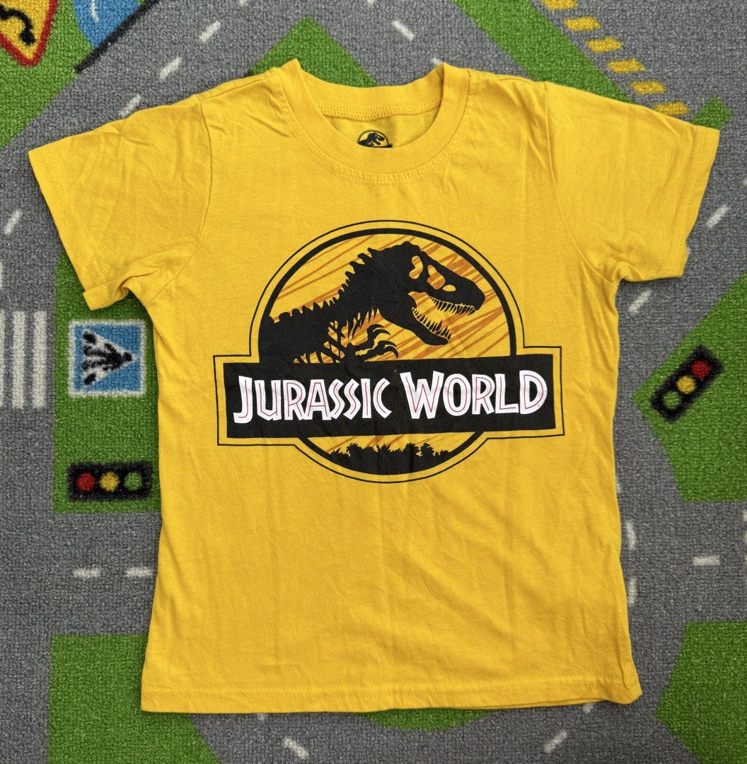Jurassic World Dinosaur T-Shirt (Category: Babies & Kids Fashion) located in Rizal. Submitted by preloovved (Listing ID 1469220631, Image 1). Description: Bright yellow Jurassic World kids t-shirt in comfortable cotton. Features a cool dinosaur skeleton graphic and classic crew neck. Perfect everyday wear for little dino fans! Preloved, 6-7yo Meet-up only in GB1 San Mateo, Rizal Shipping fee c/o buyer. Tres Marias or J&T express Payment to be sen
