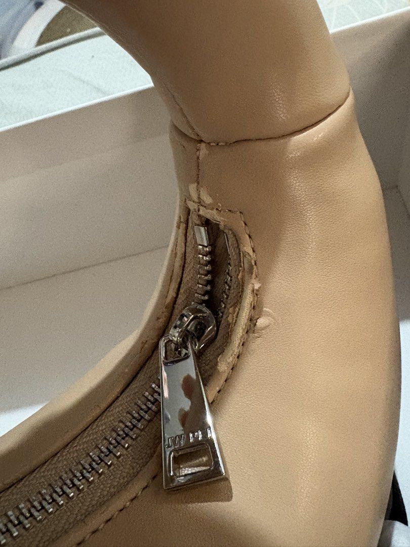 JW PEI Abacus Top Handle Bag (Category: Shoulder Bags) located in Makati City. Submitted by amarthas.closet (Listing ID 1469217616, Image 3). Description: - Color: Beige - Material: Vegan leather - Condition: Shows some wear and peeling near the zipper pull and along the seam. All flaws are shown in the pics. - Inclusions: Original box and white dust bag included .