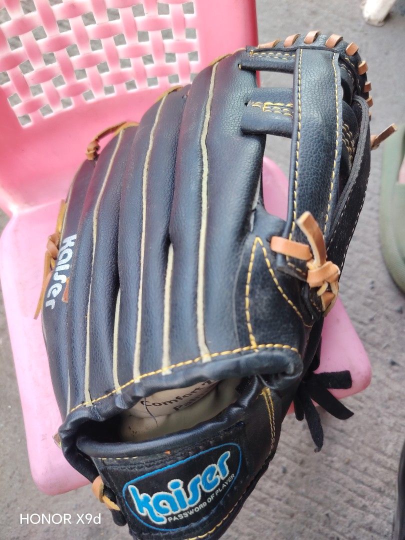 Kaiser 12 Inch Baseball Glove (Category: Racket and Ball Sports) located in Manila. Submitted by mightypenguin_44c1b5 (Listing ID 1469213441, Image 2). Description: - Brand: Kaiser - Size: 12 inches - Color: Black with contrasting tan lacing and yellow stitching - Design: Professional model with a deep set pocket for secure catches - Comfort: Features a soft palm lining for added comfort - Best for: Practice sessions and casual games - Condition: