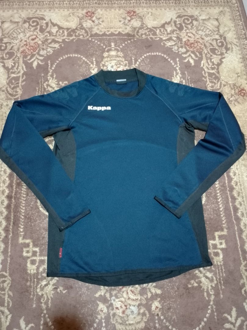 Kappa Blue Long Sleeve Athletic Track Jersey (Category: Longsleeves) located in Bayombong. Submitted by daily10 (Listing ID 1469192875, Image 3). Description: - Brand: Kappa - Size: M-L - Dimensions: 20" x 27f" x 28b" - Faded prints - Color: Blue and black with white logo and red brand tag - Style: Long sleeve sports top with ribbed crew neck, dark side panels, and sleeve cuffs - Material: Soft athletic fabric inside for extra comfort - Best for: