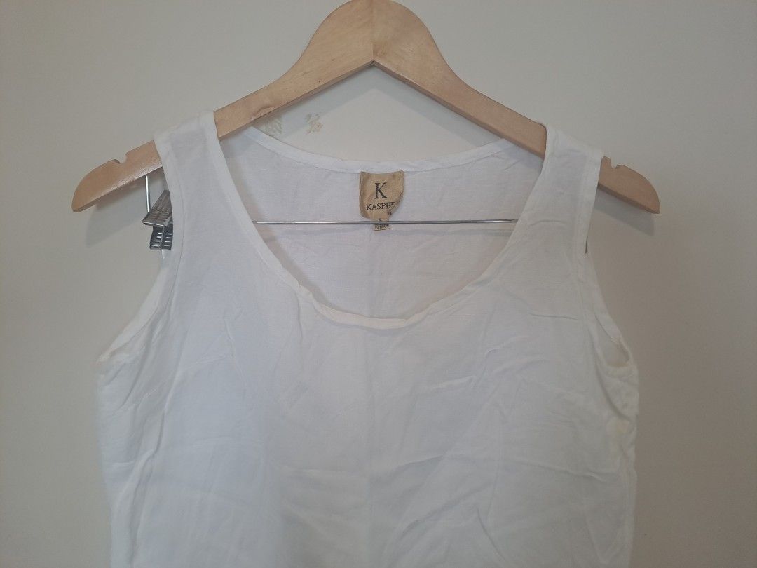 Kasper 100 % linen (Category: Sleeveless) located in Manila. Submitted by joanbalde39643 (Listing ID 1469204478, Image 2). Description: The item shown is a white linen sleeveless scoop-neck tank top, featuring wide shoulder straps and a relaxed, breezy silhouette. Based on the interior label, the brand is Kaspe (or Kasper), a label known for lightweight, breathable natural-fiber basics perfect for layering or warm weather.