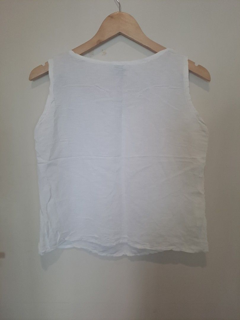 Kasper 100 % linen (Category: Sleeveless) located in Manila. Submitted by joanbalde39643 (Listing ID 1469204478, Image 3). Description: The item shown is a white linen sleeveless scoop-neck tank top, featuring wide shoulder straps and a relaxed, breezy silhouette. Based on the interior label, the brand is Kaspe (or Kasper), a label known for lightweight, breathable natural-fiber basics perfect for layering or warm weather.