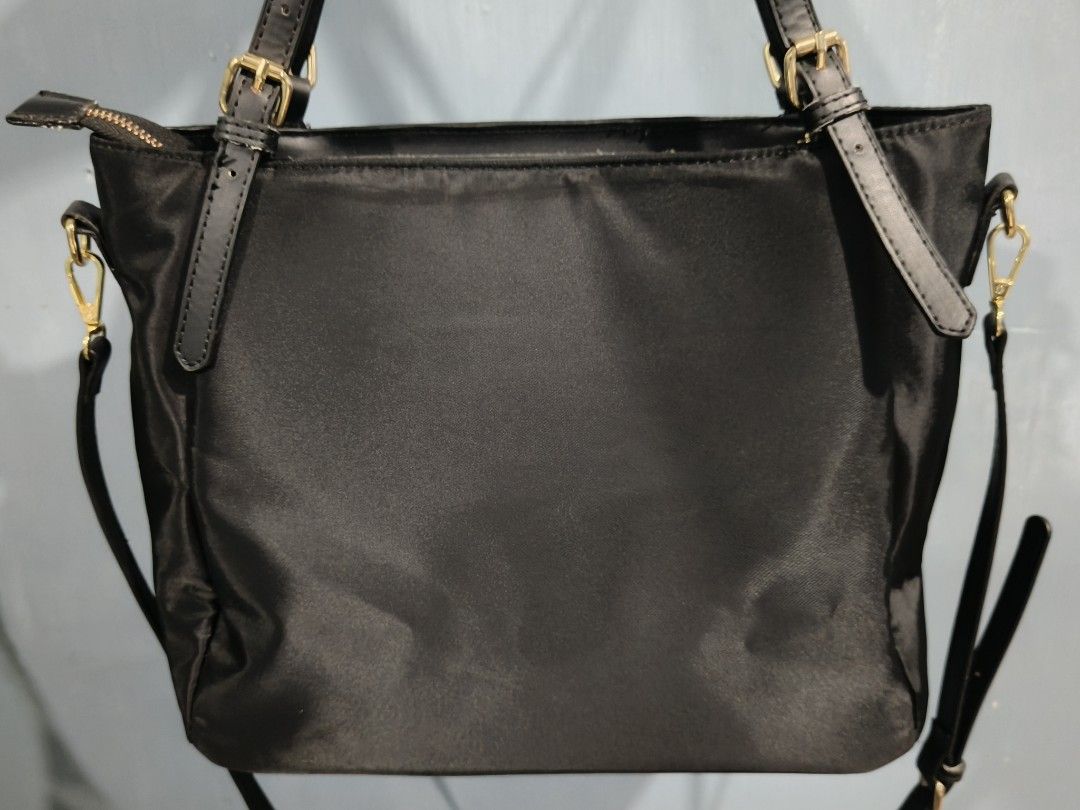 Kate Spade Black Nylon Shoulder Bag (Category: Luxury Bags & Wallets) located in Manila. Submitted by _cee02 (Listing ID 1469250578, Image 2). Description: - Brand: Kate Spade New York - Color/Material: Black nylon with gold-tone hardware - Closure: Secure top zipper - Features: Sturdy black shoulder straps, clean everyday silhouette - Interior: Includes style number tag (KATE28S121PA001) - Origin: Made in Vietnam - Condition: Excellent daily wea