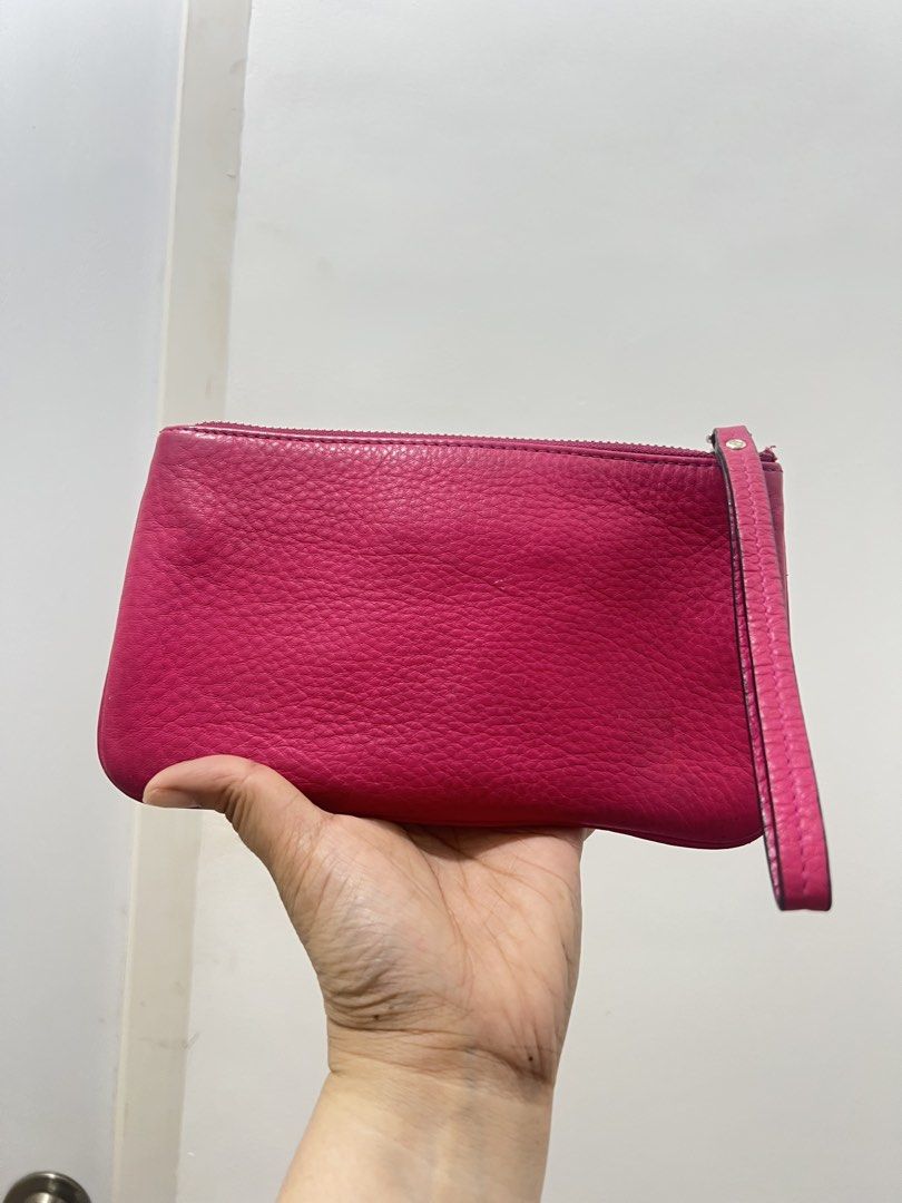 Kate Spade Pink Leather Wristlet Pouch (Category: Wallets & Card holders) located in Antipolo. Submitted by luxurieslvoes (Listing ID 1469201106, Image 2). Description: - Brand: Kate Spade New York - Material: Bright pink pebbled leather - Hardware: Gold-tone - Closure: Top zipper - Features: Attached side wrist strap, front gold metal logo plate with stud corners - Interior: Clean lining - Size: Compact (ideal for cards, cash, and keys) - Condit