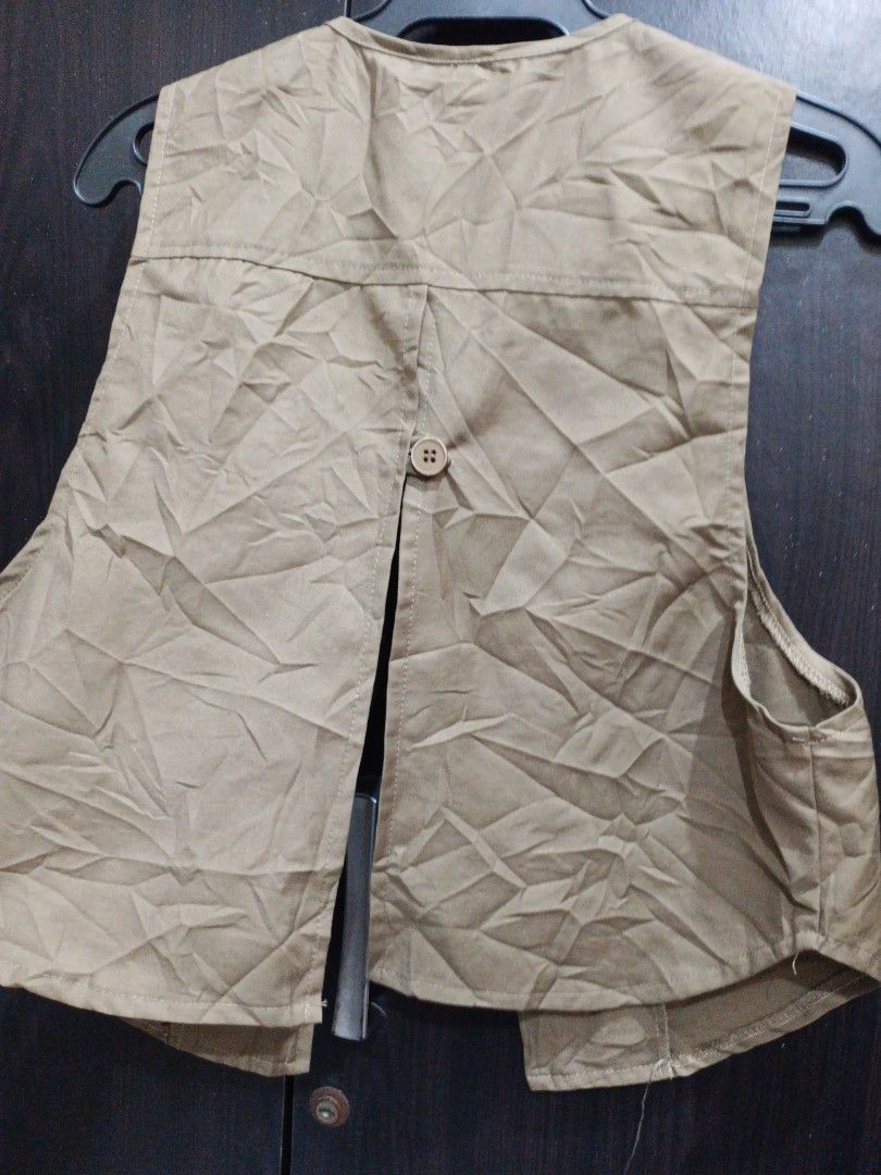 Khaki Utility Vest Size 3XL (Category: Sleeveless) located in Manila. Submitted by ggarage.sale (Listing ID 1469207734, Image 3). Description: Khaki utility vest in size 3XL. Open front design with two lower patch pockets. Lightweight cotton fabric with visible wrinkles from storage. Tag shows size 3XL at the collar. Great extra layer for outdoor activities or casual everyday outfits..