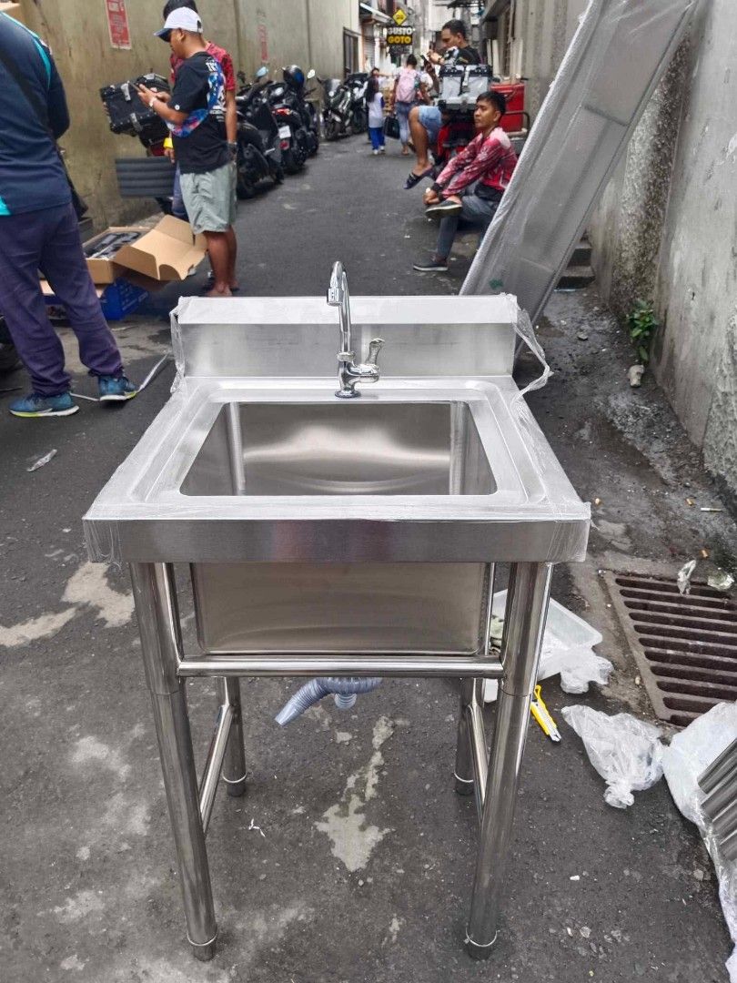 Kitchen Sink with Stand (Category: Bathroom & Kitchen Fixtures) located in Manila. Submitted by acykt18 (Listing ID 1469361410, Image 1). Description: - Heavy-duty stainless steel kitchen sink setup - Available in single, double, and triple basin configurations - Includes complete accessories: faucets, legs, backsplash, and drainage pipes - Durable grade steel built for commercial or heavy home use - Easy to clean with a sturdy tubular frame supp