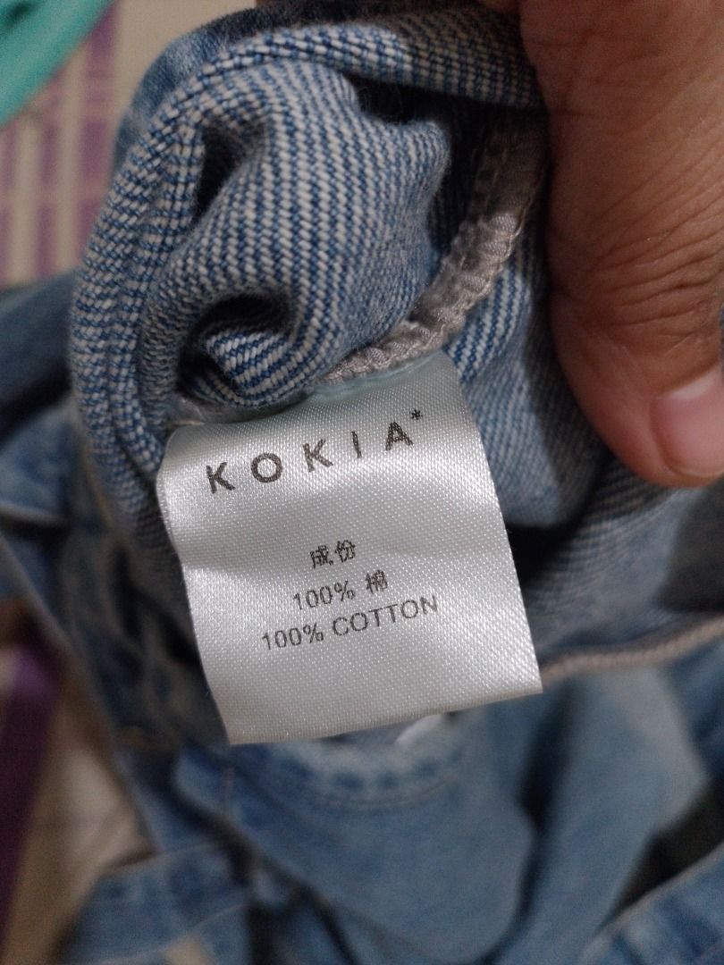 Kokia Denim Tote Bag with Embroidered Monogram and Patch (Category: Tote Bags) located in Imus. Submitted by bestfinds_yeth0724 (Listing ID 1469379836, Image 3). Description: - Brand: Kokia - Material: 100% cotton denim in light blue wash - Design: White embroidered monogram on the front and brown leather patch with embossed 'K' on the back - Closure: Secure magnetic snap - Carry: Double top handles - Features: Roomy interior, perfect for daily u