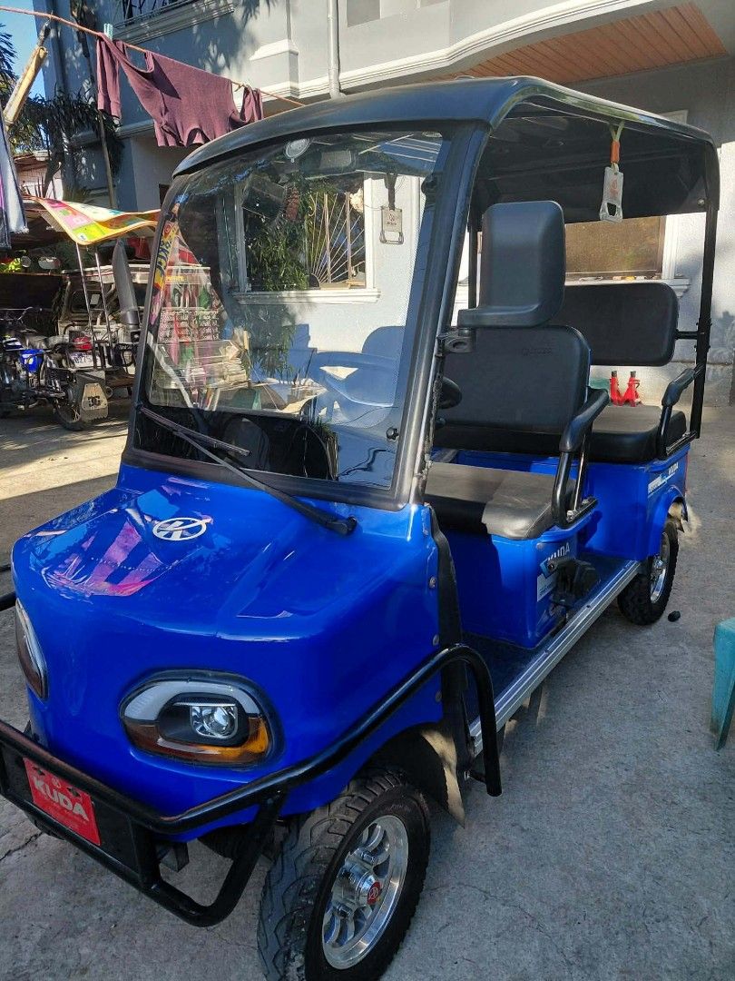 Kuda Lion ebike 4wheels (Category: Golf) located in Manila. Submitted by yukinatsumi (Listing ID 1469190063, Image 1). Description: - Color: Bright blue with black roof and seating setup - Type: Fully operational electric passenger cart - Design: Open-air cabin featuring a front windshield and wiper - Capacity: Dual passenger rows equipped with safety grab rails - Exterior: Heavy-duty upfront bumper guard and chrome alloy wheels - Condition: Read
