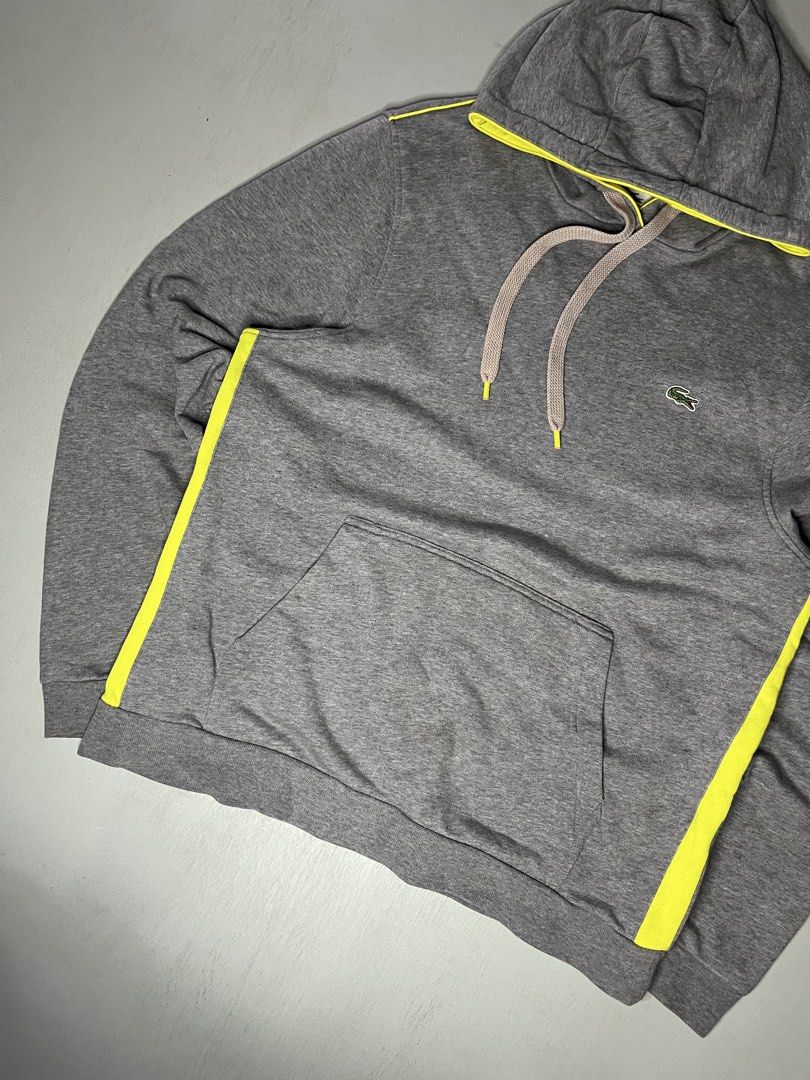 LACOSTE (Category: Coats, Jackets and Outerwear) located in Catbalogan. Submitted by wayndsyclee. (Listing ID 1469329700, Image 3). Description: Lacoste gray pullover hoodie featuring neon lime-yellow side stripes, a matching hood trim, and the brand’s signature green crocodile embroidered on the left chest EXCELLENT CONDITON COLOR RATE 9/10 No issue Dimes:W22/L27.