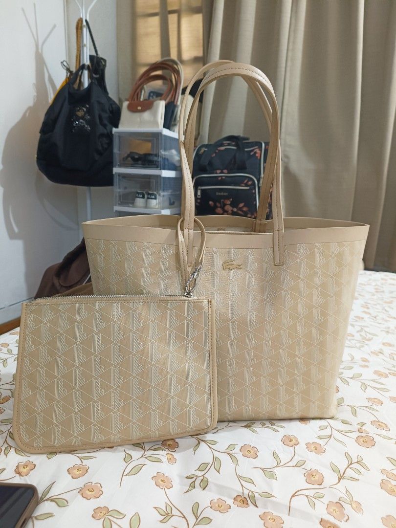 Lacoste Beige Tote Bag With Pouch (Category: Tote Bags) located in Baguio. Submitted by maria.s0329822318 (Listing ID 1469222810, Image 2). Description: - Brand: Lacoste - Color/Design: Beige with all-over geometric monogram print - Features: Signature metal crocodile logo on the front, structured shape, and dual shoulder handles - Organization: Multiple interior compartments to keep your essentials organized - Inclusion: Comes with a matching zi