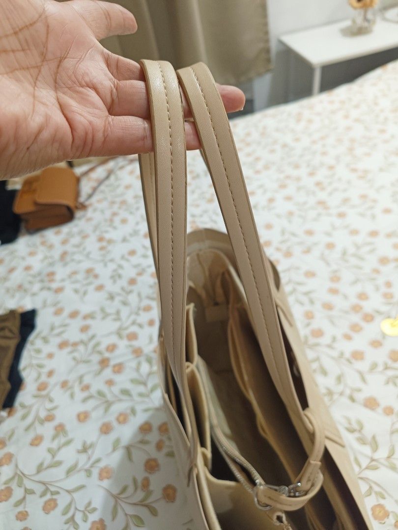 Lacoste Beige Tote Bag With Pouch (Category: Tote Bags) located in Baguio. Submitted by maria.s0329822318 (Listing ID 1469222810, Image 3). Description: - Brand: Lacoste - Color/Design: Beige with all-over geometric monogram print - Features: Signature metal crocodile logo on the front, structured shape, and dual shoulder handles - Organization: Multiple interior compartments to keep your essentials organized - Inclusion: Comes with a matching zi