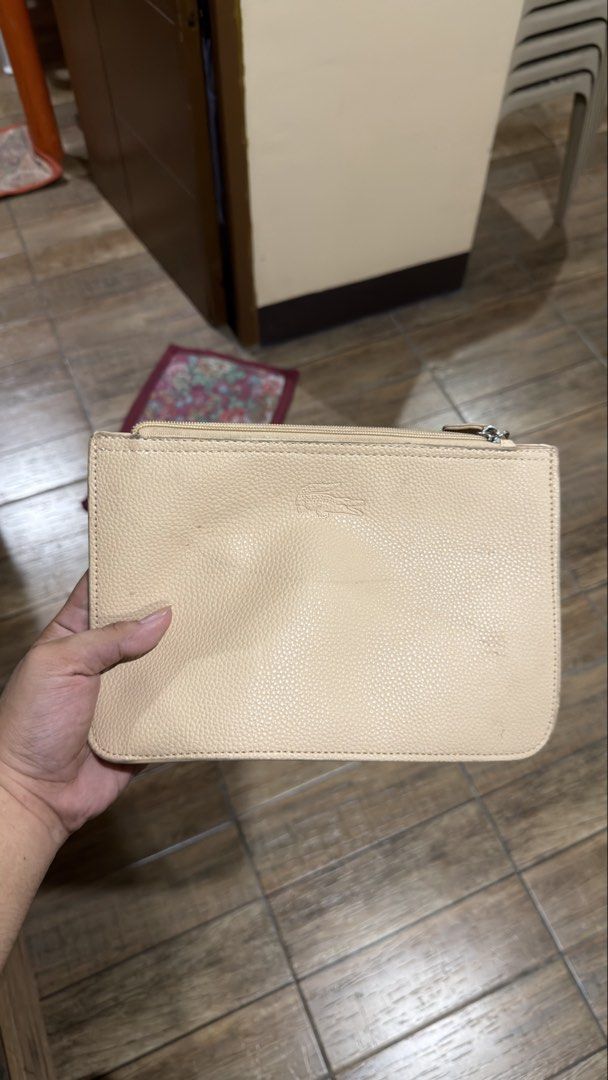 LACOSTE CREAM POUCH (Category: Purses & Pouches) located in Manila. Submitted by urban.vintage (Listing ID 1469309784, Image 1). Description: ISSUE: NONE (NEED WASH) MOP :GCASH (NO COD) SHIP VIA: LALAMOVE & J&T LOCATION: PASIG CITY.