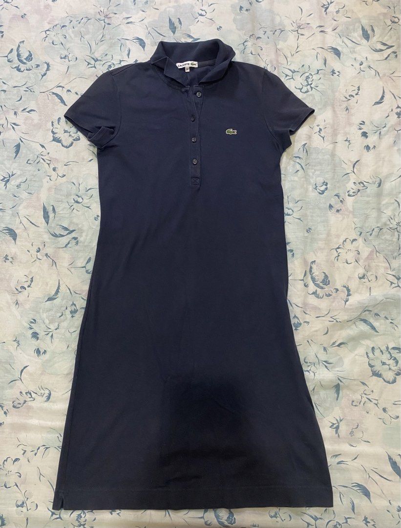 Lacoste Navy Blue Polo Dress (Category: Dresses) located in Lucena. Submitted by selenaandco (Listing ID 1469201743, Image 2). Description: - Brand: Lacoste - Color: Dark Blue - Material: Comfortable cotton pique fabric - Design: Classic polo collar with front button placket - Details: Short sleeves with ribbed cuffs and signature embroidered green crocodile logo on the chest - Style: Clean, classic, and sporty - ideal for casual outings or tenni