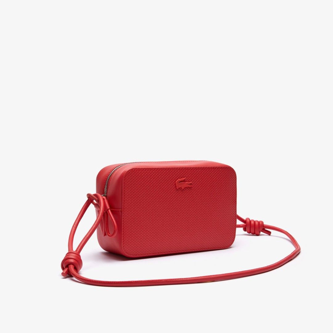 Lacoste Red Leather Crossbody Bag Camera Bag (Category: Cross-body Bags) located in Paranaque City. Submitted by everydaymonday (Listing ID 1469302432, Image 1). Description: - Authentic bright red Lacoste crossbody camera bag - Textured body with sleek smooth leather trim - Tonal debossed crocodile logo on the front - Secure zip-top closure with metallic hardware - Slim rounded shoulder strap with stylish side knot details - Compact and minimali
