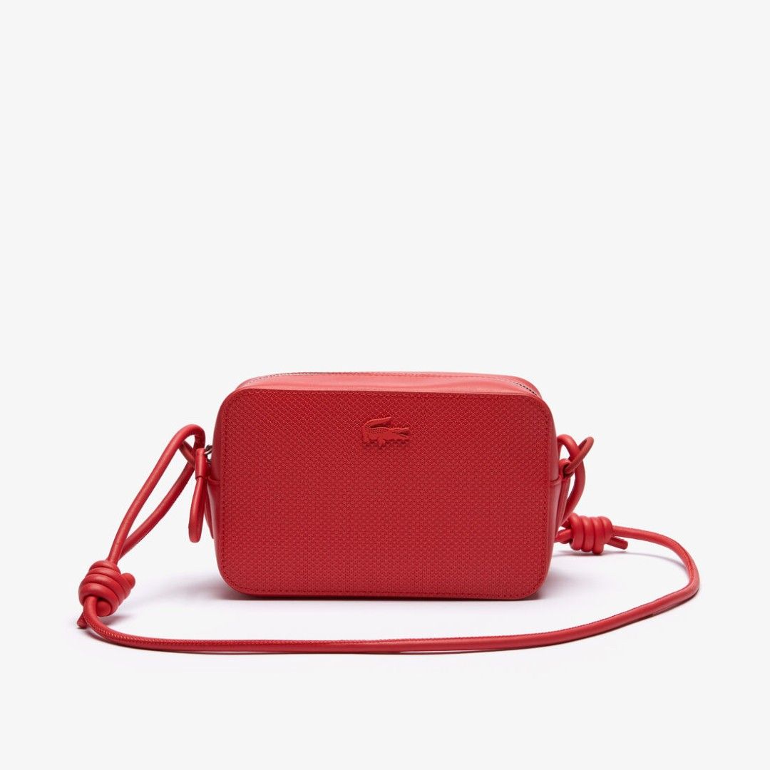 Lacoste Red Leather Crossbody Bag Camera Bag (Category: Cross-body Bags) located in Paranaque City. Submitted by everydaymonday (Listing ID 1469302432, Image 2). Description: - Authentic bright red Lacoste crossbody camera bag - Textured body with sleek smooth leather trim - Tonal debossed crocodile logo on the front - Secure zip-top closure with metallic hardware - Slim rounded shoulder strap with stylish side knot details - Compact and minimali