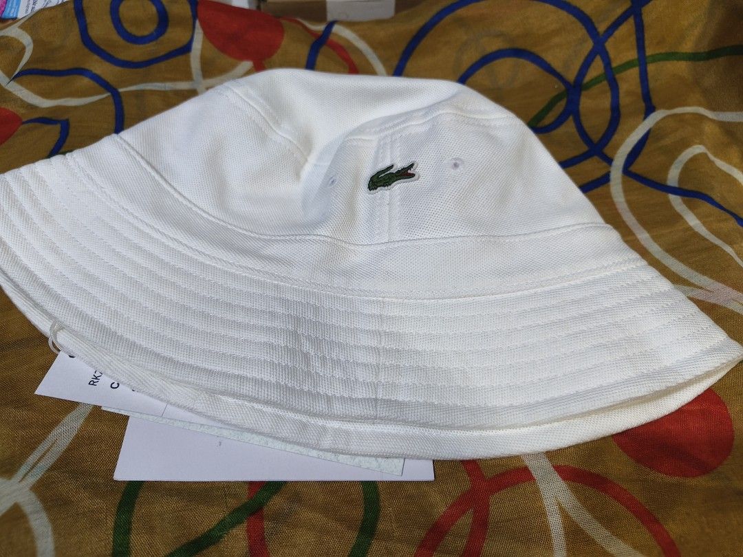 Lacoste Unisex bucket hat Large (Category: Hats & Beanies) located in Paranaque City. Submitted by fabbieb (Listing ID 1469173072, Image 2). Description: Lacoste Bucket Hat White Large New with tags No paper bag 💯authentic merchandise ❗NO when worn photo-- white item, iwas mantsa... hair oil. thanks for understanding. ❗first photo(collage) from brand's site. Ctto. Used for reference only. P2500 plus SF Location: Parañaque City ➡️ NO RUSH SHIPPIN