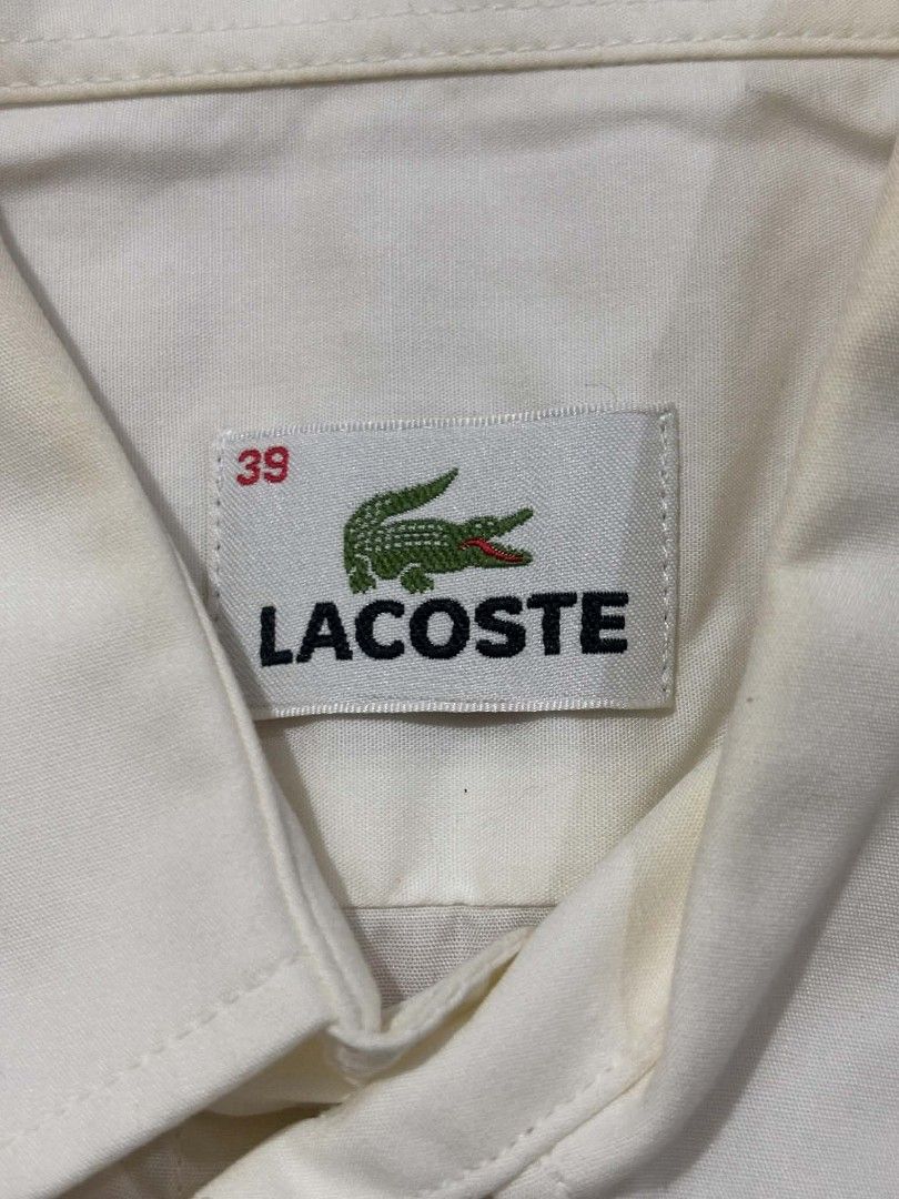 Lacoste White Button-Up Shirt Size 39 (Category: Shirts) located in Paranaque City. Submitted by poego (Listing ID 1469270972, Image 3). Description: - Brand: Lacoste - Style: White button-up shirt / Smart casual & office wear - Size: 39 (Tagged at neck) - Fit: Standard fit - Material: Clean, breathable cotton - Details: Point collar, front button placket, single chest pocket with embroidered crocodile logo, branded mother-of-pearl buttons - Cond