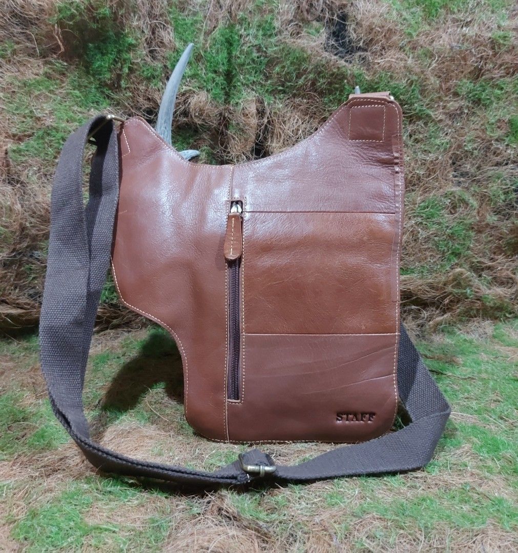 Leather slingbag (Category: Sling Bags) located in Baguio. Submitted by swiftdragon.1466ef (Listing ID 1469295119, Image 3). Description: thrifted bag. staff brand cowhide leather slingbag for men euc.. L-12", H-12.5", W-2.5"... j&t courier payment first plus sf, baguio city location .